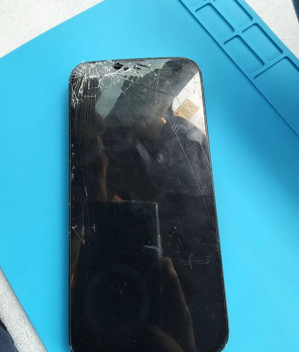 Cracked phone screen before repair, photographed by Mobile Fix Near Me